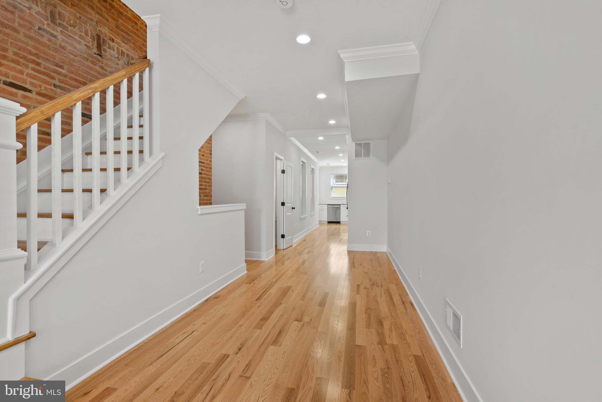 1005 Riverside Avenue Baltimore, MD 21230 - Photo 7 of 29 a view of a hallway with wooden floor and staircase