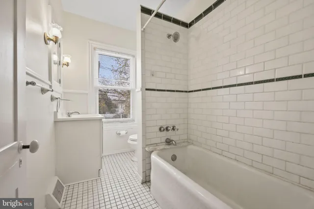 a bathroom with a bathtub a toilet and a shower