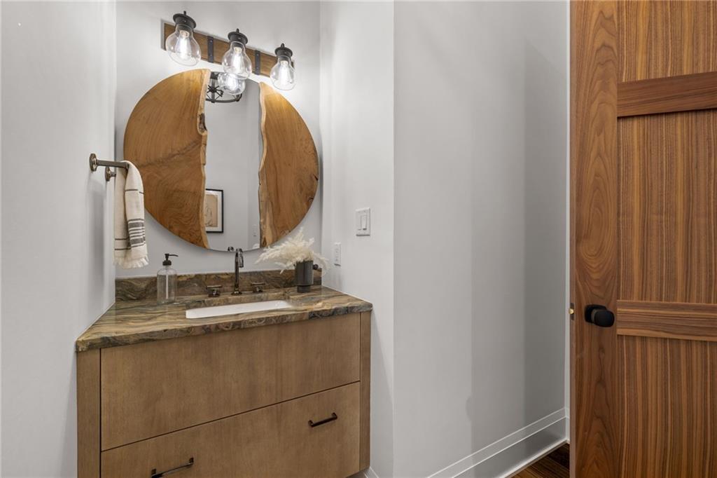 10485 Grubbs Road Wexford, PA 15090 - Photo 19 of 50 Main level powder room with Rutt cabinetry, Armina Stonefusion counters, and live edge mirror