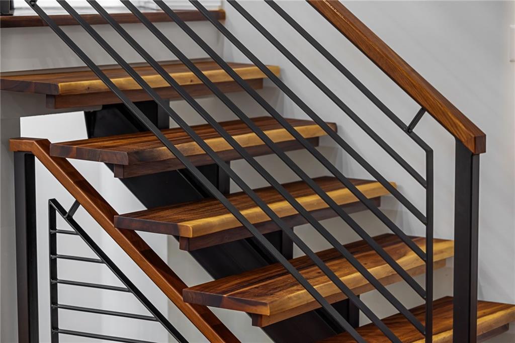 10485 Grubbs Road Wexford, PA 15090 - Photo 28 of 50 Detailed view of the custom stairwell featuring a floating staircase, live edge acacia wood treads, and a hand fabricated railing.