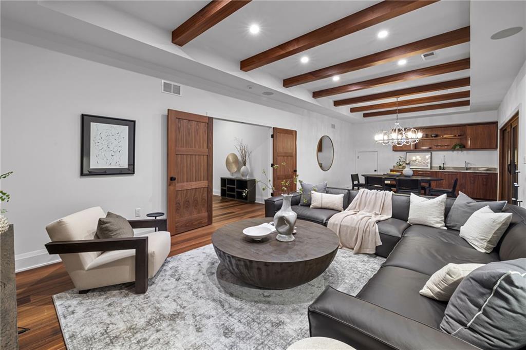 10485 Grubbs Road Wexford, PA 15090 - Photo 37 of 50 French door access leads to the upper game room with wood beam accents. This room opens to a covered upper deck too! There also is a built-in wet bar with Armina Stone Vancouver leathered countertops. Perfect for entertaining!