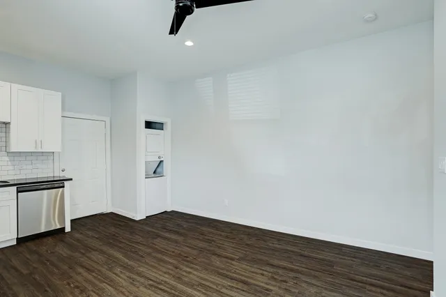 a view of a kitchen with wooden floor and a sink