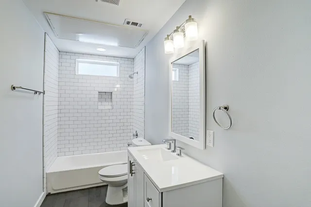 a bathroom with a sink toilet and shower
