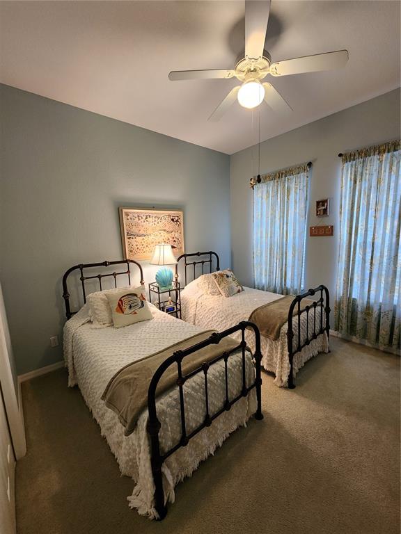 400 Ravinia Circle, Unit 400 Venice, FL 34292 - Photo 17 of 31 a spacious bedroom with two beds and a chandelier