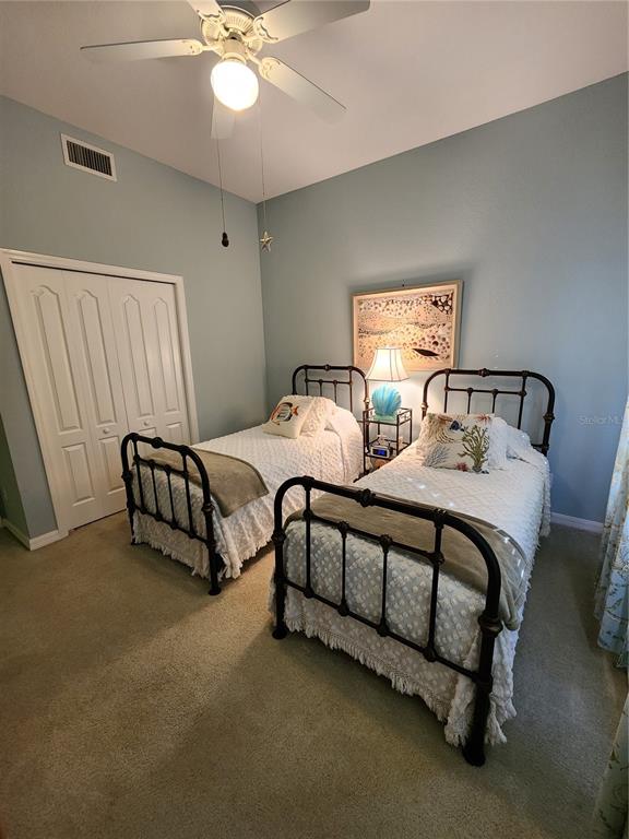 400 Ravinia Circle, Unit 400 Venice, FL 34292 - Photo 18 of 31 a spacious bedroom with two beds and a chandelier