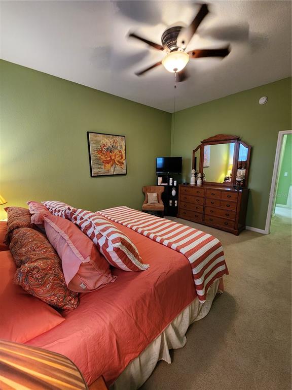 400 Ravinia Circle, Unit 400 Venice, FL 34292 - Photo 21 of 31 a bedroom with a bed and a chandelier