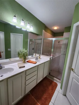 a bathroom with a double vanity sink and a mirror
