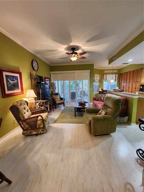400 Ravinia Circle, Unit 400 Venice, FL 34292 - Photo 3 of 31 a living room with furniture and a chandelier
