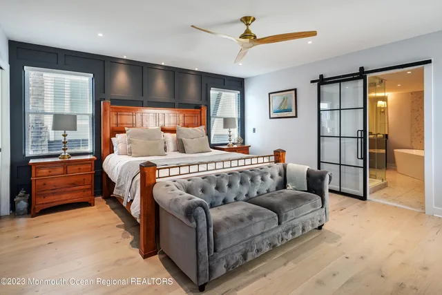 a bedroom with a large bed and a chandelier