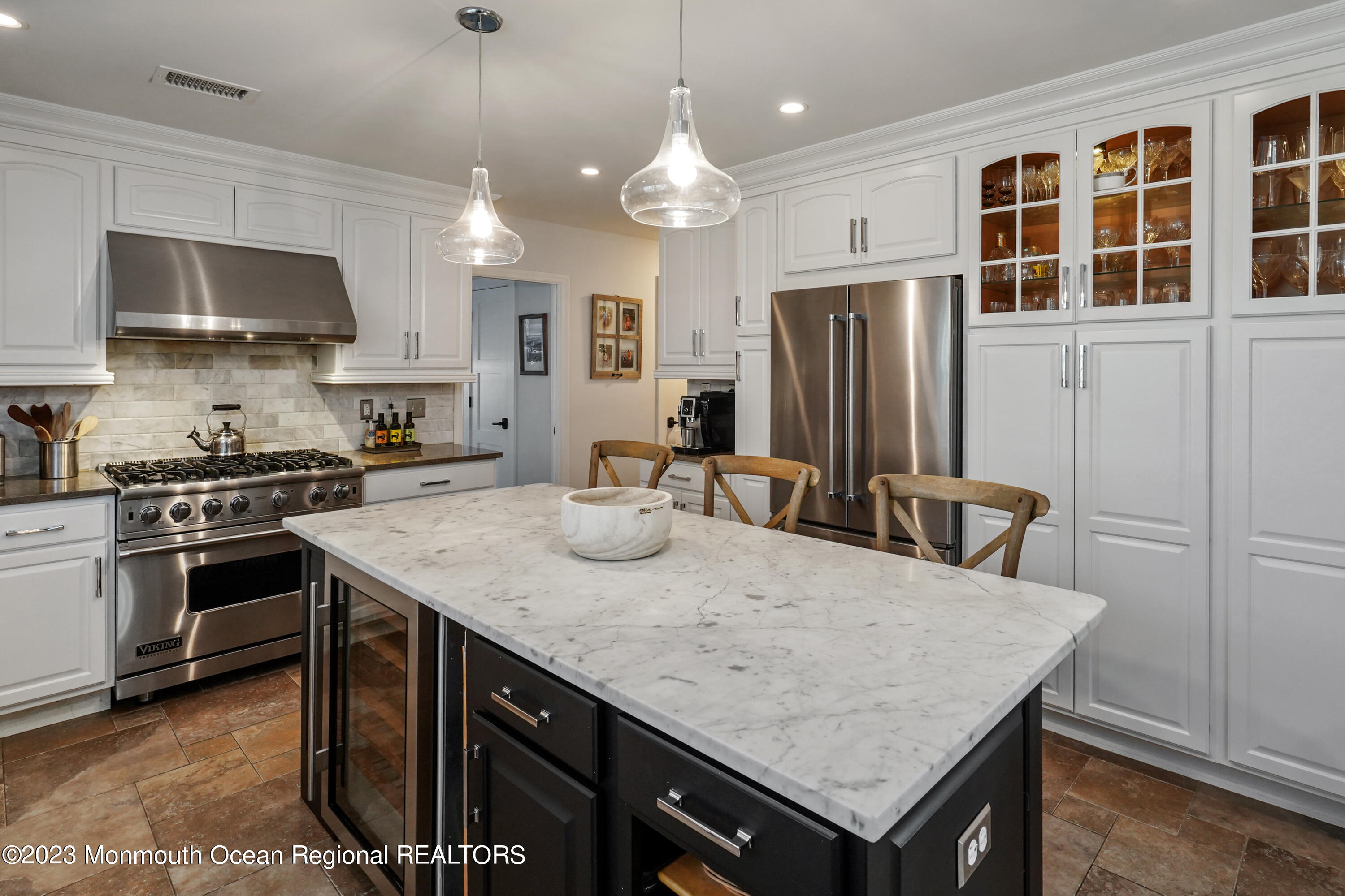 315 Ludlow Avenue Spring Lake, NJ 07762 - Photo 14 of 31 a kitchen with stainless steel appliances granite countertop a kitchen island a stove a refrigerator a sink a dining table and chairs