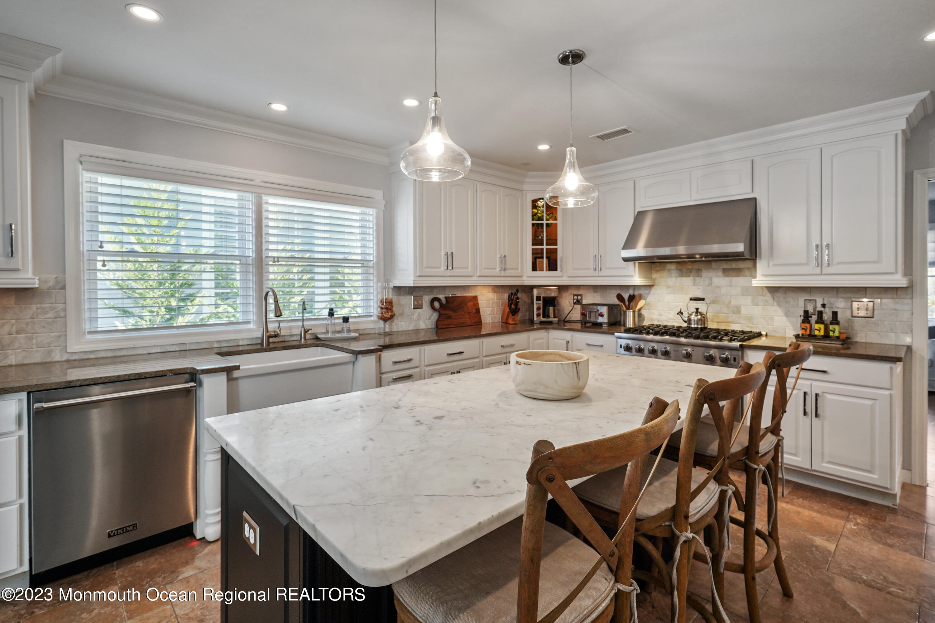 315 Ludlow Avenue Spring Lake, NJ 07762 - Photo 15 of 31 a kitchen with a dining table chairs sink and cabinets
