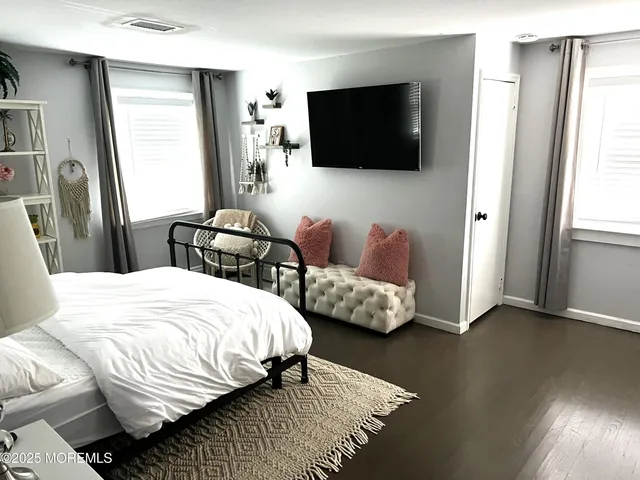 a bedroom with bed and a flat screen tv