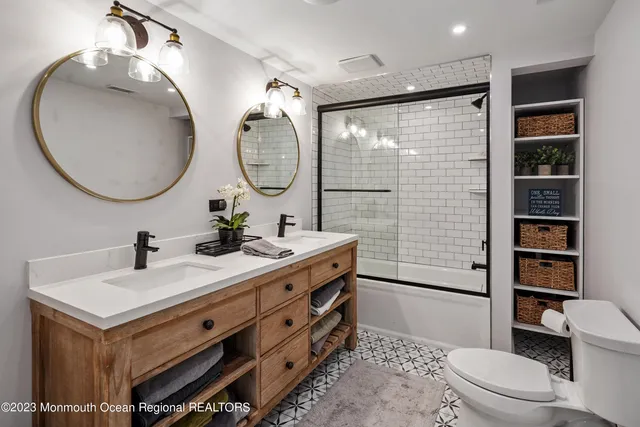 a bathroom with a toilet a sink and a mirror