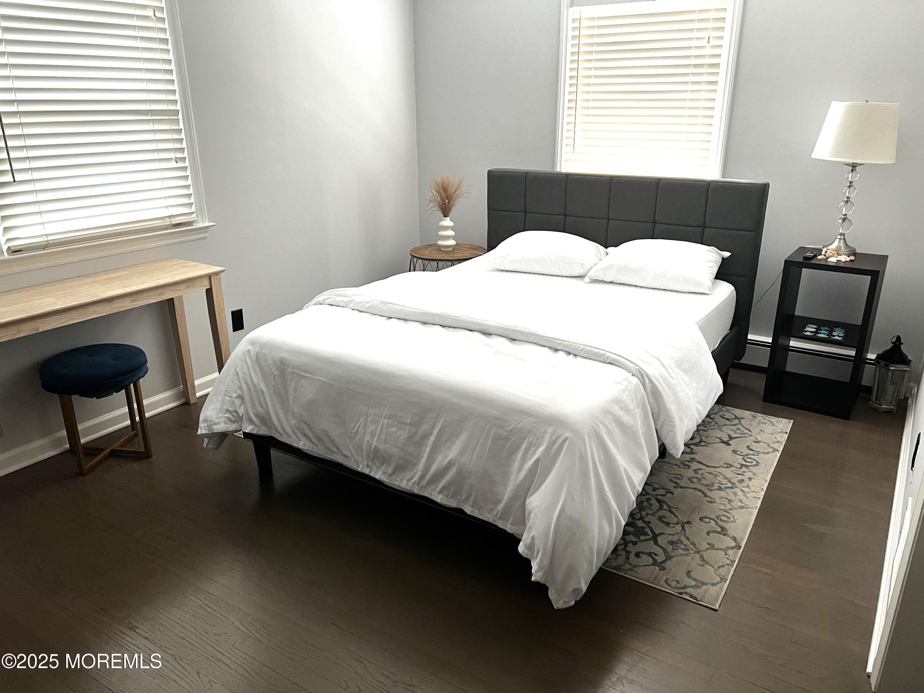 315 Ludlow Avenue Spring Lake, NJ 07762 - Photo 20 of 31 a bedroom with a bed and a lamp