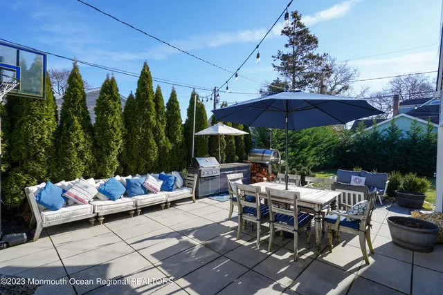 a patio with a patio table and chairs
