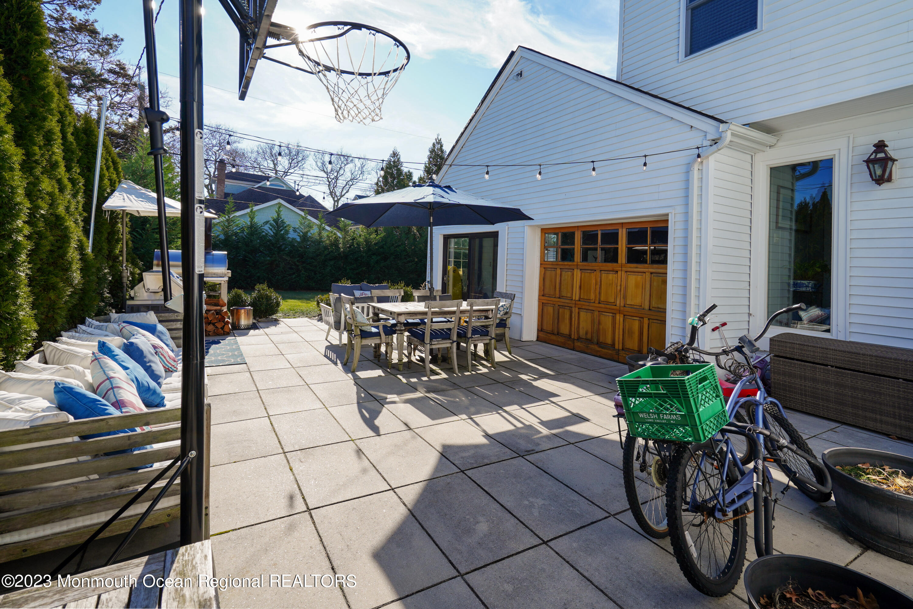 315 Ludlow Avenue Spring Lake, NJ 07762 - Photo 25 of 31 a view of a patio with table and chairs potted plants and a large tree