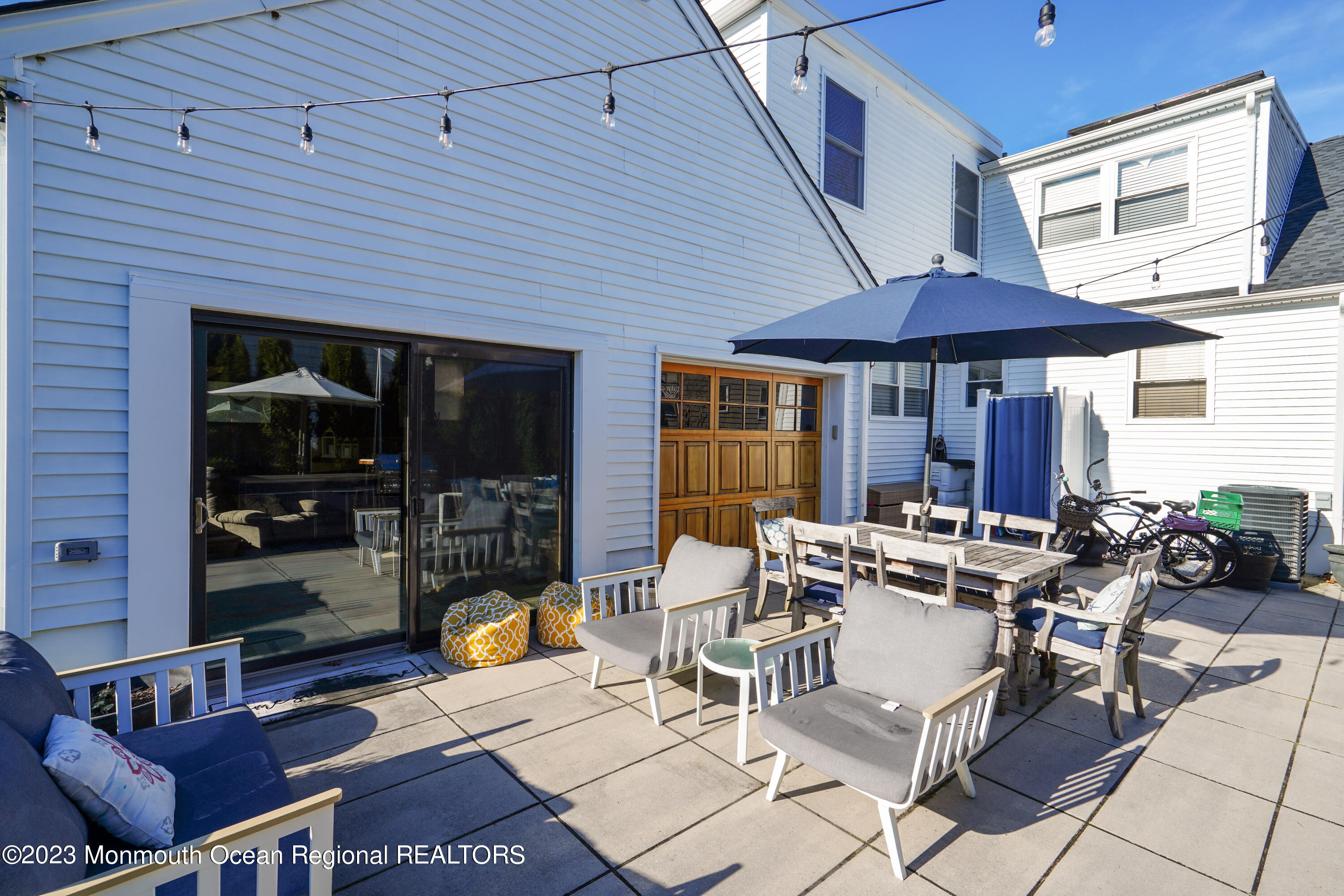 315 Ludlow Avenue Spring Lake, NJ 07762 - Photo 26 of 31 a view of a patio with table and chairs under an umbrella