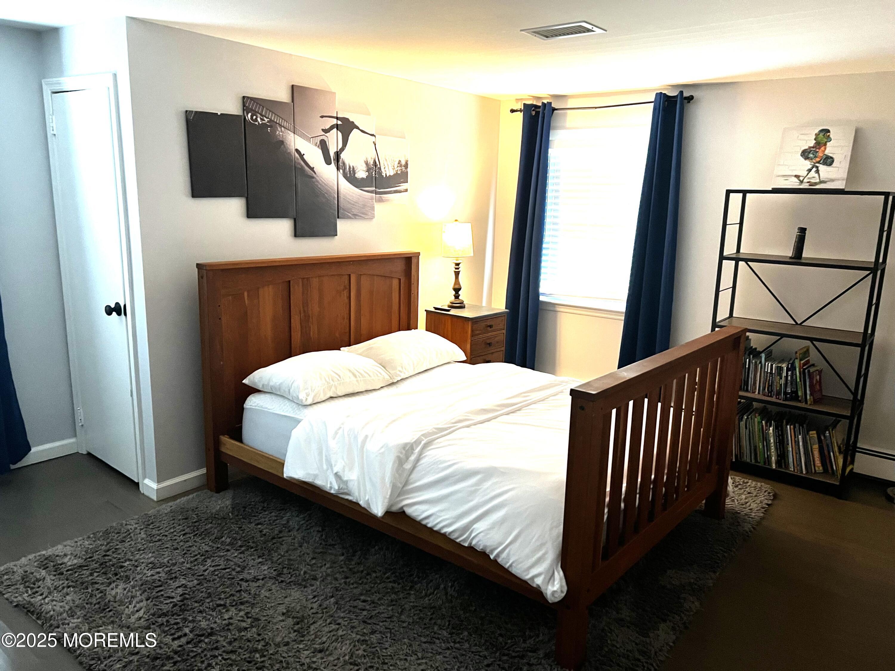 315 Ludlow Avenue Spring Lake, NJ 07762 - Photo 28 of 31 a bed sitting in a bedroom next to a window with pc on the table