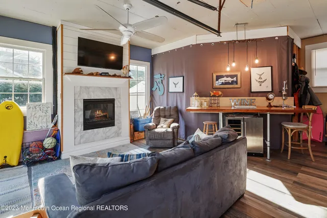 a living room with furniture a fireplace and a flat screen tv