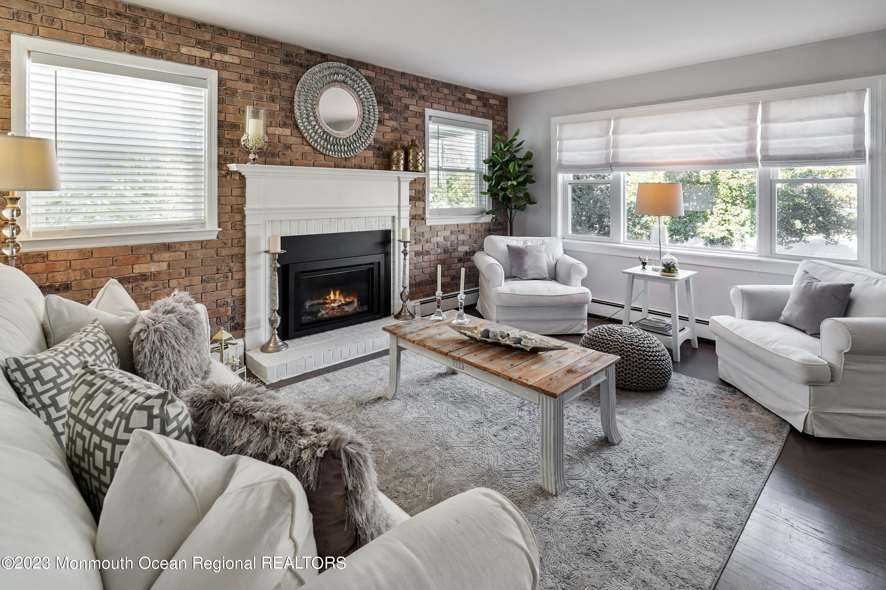 315 Ludlow Avenue Spring Lake, NJ 07762 - Photo 3 of 31 a living room with furniture a large window and a fireplace