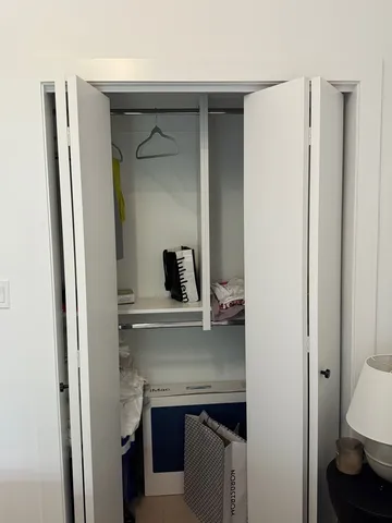 a living room with furniture gym equipment and large window