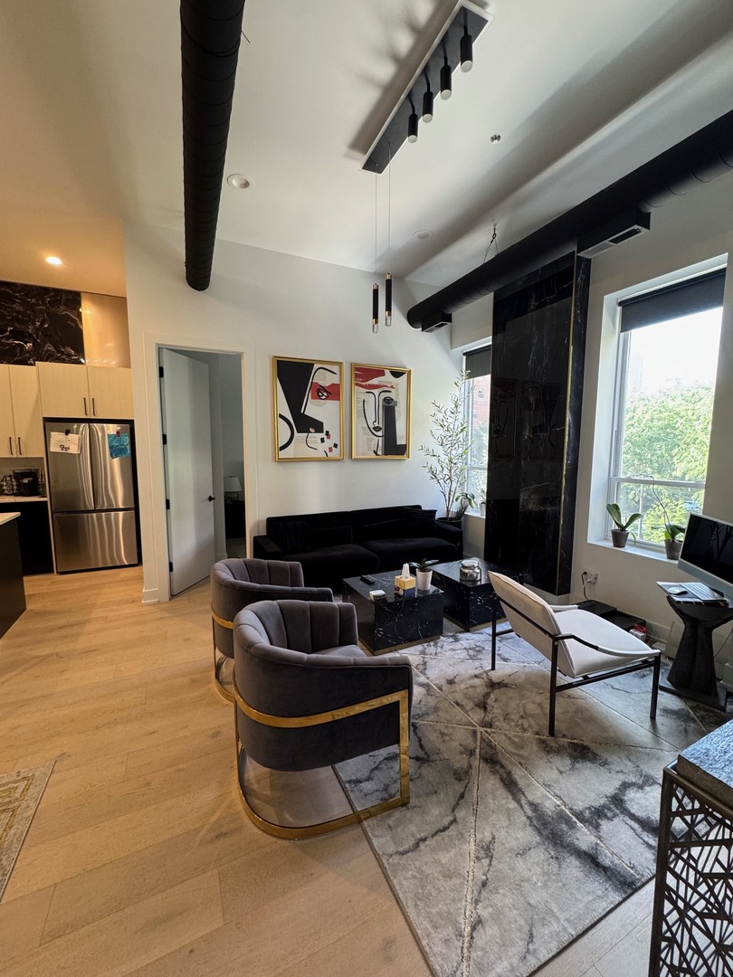 77 West Chestnut Street, Unit 3B Chicago, IL 60610 - Photo 13 of 14 a living room with furniture gym equipment and large window