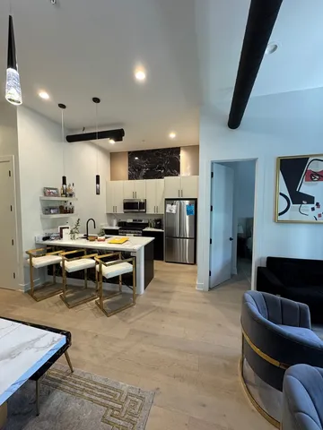 a living room with furniture and a kitchen view