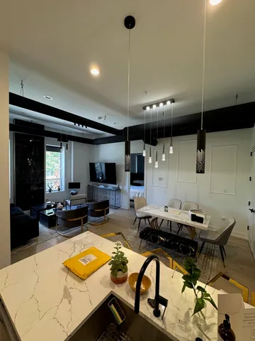 a living room with furniture a flat screen tv and a table