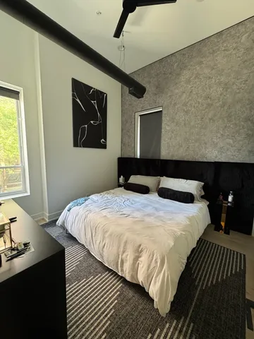 a bedroom with a bed and a desk