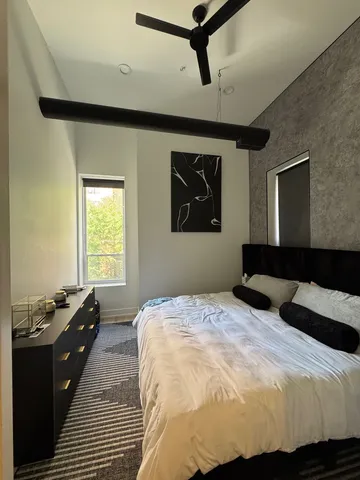 a bedroom with a bed and a window