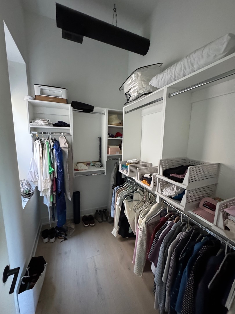 77 West Chestnut Street, Unit 3B Chicago, IL 60610 - Photo 10 of 14 a view of walk in closet with clothes and shoes