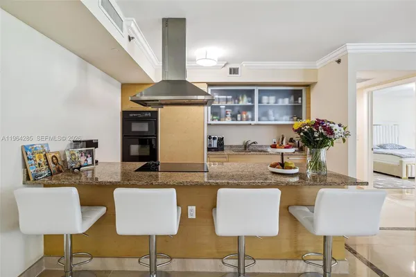 a kitchen with a dining table chairs and a stove