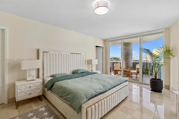 a bedroom with a bed and a large window