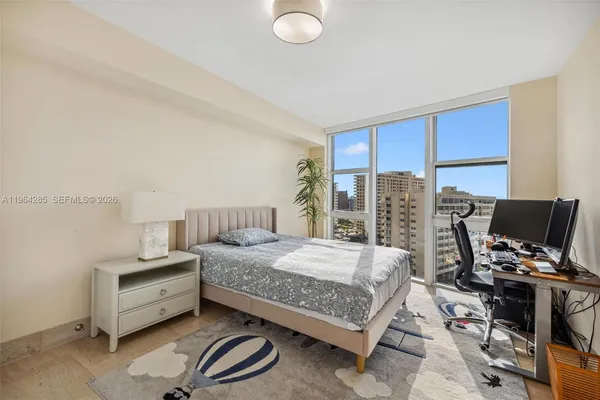 a bedroom with a bed and a desk