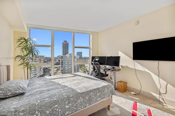 a bedroom with a bed and flat screen tv