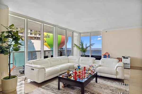 a living room with furniture and a large window