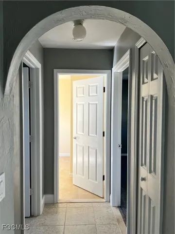 a view of a hallway with entryway and front door