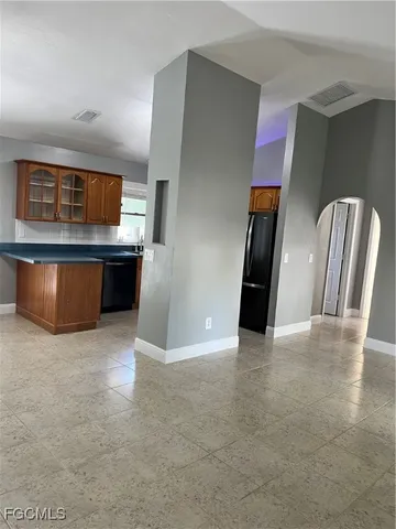 a view of kitchen with stainless steel appliances granite countertop cabinets and sink