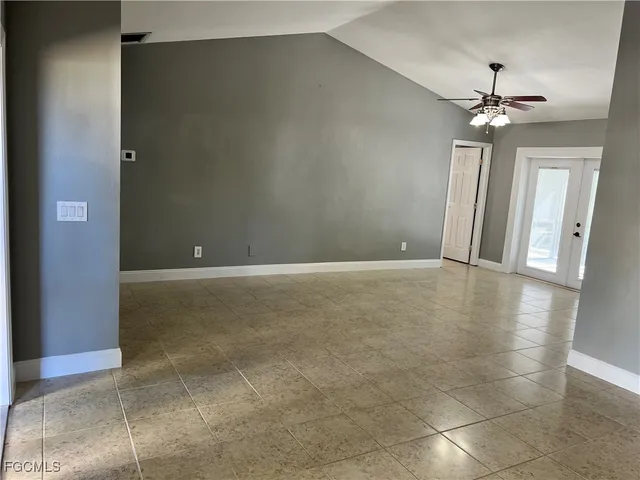 a view of a livingroom with a ceiling fan and window