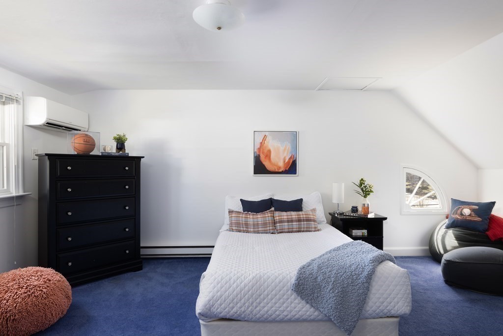 208 South Street Brookline, MA 02467 - Photo 23 of 30 a bedroom with a bed and a cabinets