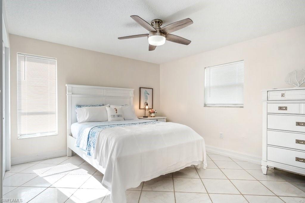 1207 Hernando Street Naples, FL 34103 - Photo 23 of 37 a bedroom with a bed and a window