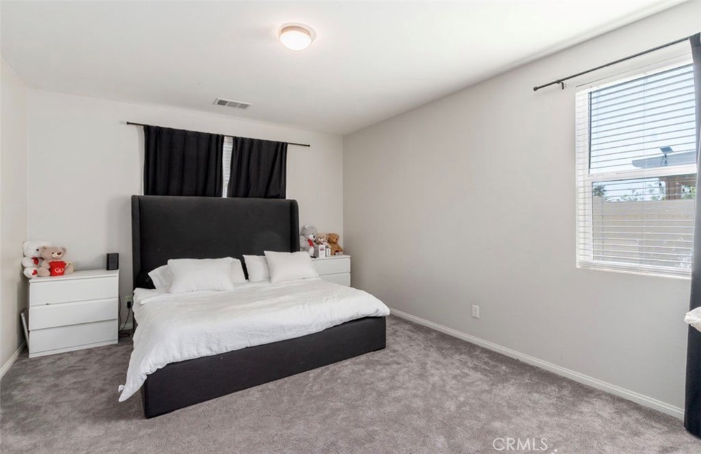 455 East Orchard Street Rialto, CA 92376 - Photo 12 of 22 a bedroom with a bed and window