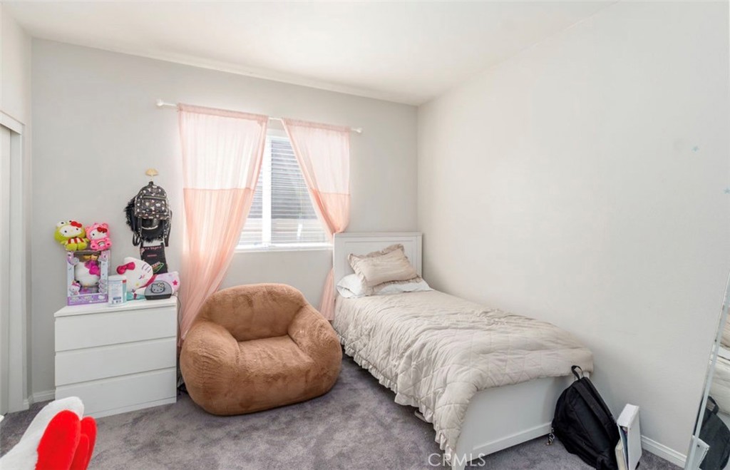 455 East Orchard Street Rialto, CA 92376 - Photo 9 of 22 a bedroom with a bed and a large window