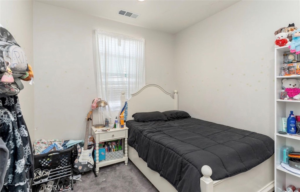455 East Orchard Street Rialto, CA 92376 - Photo 10 of 22 a bedroom with a bed and a window