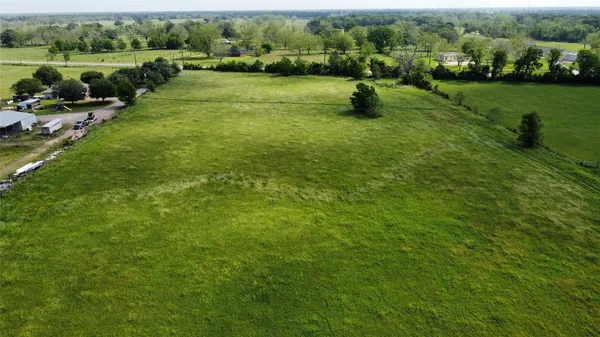 a view of a green yard with a lake view