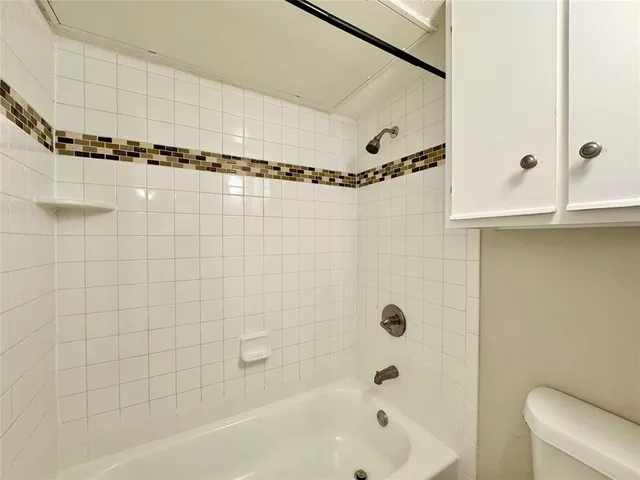 a bathroom with a shower and a bathtub