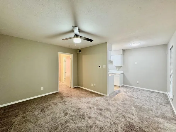 a view of an empty room with a bathroom