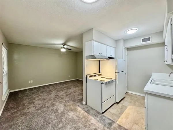 a view of a kitchen with wooden floor