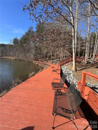 a view of a lake with couches in the patio