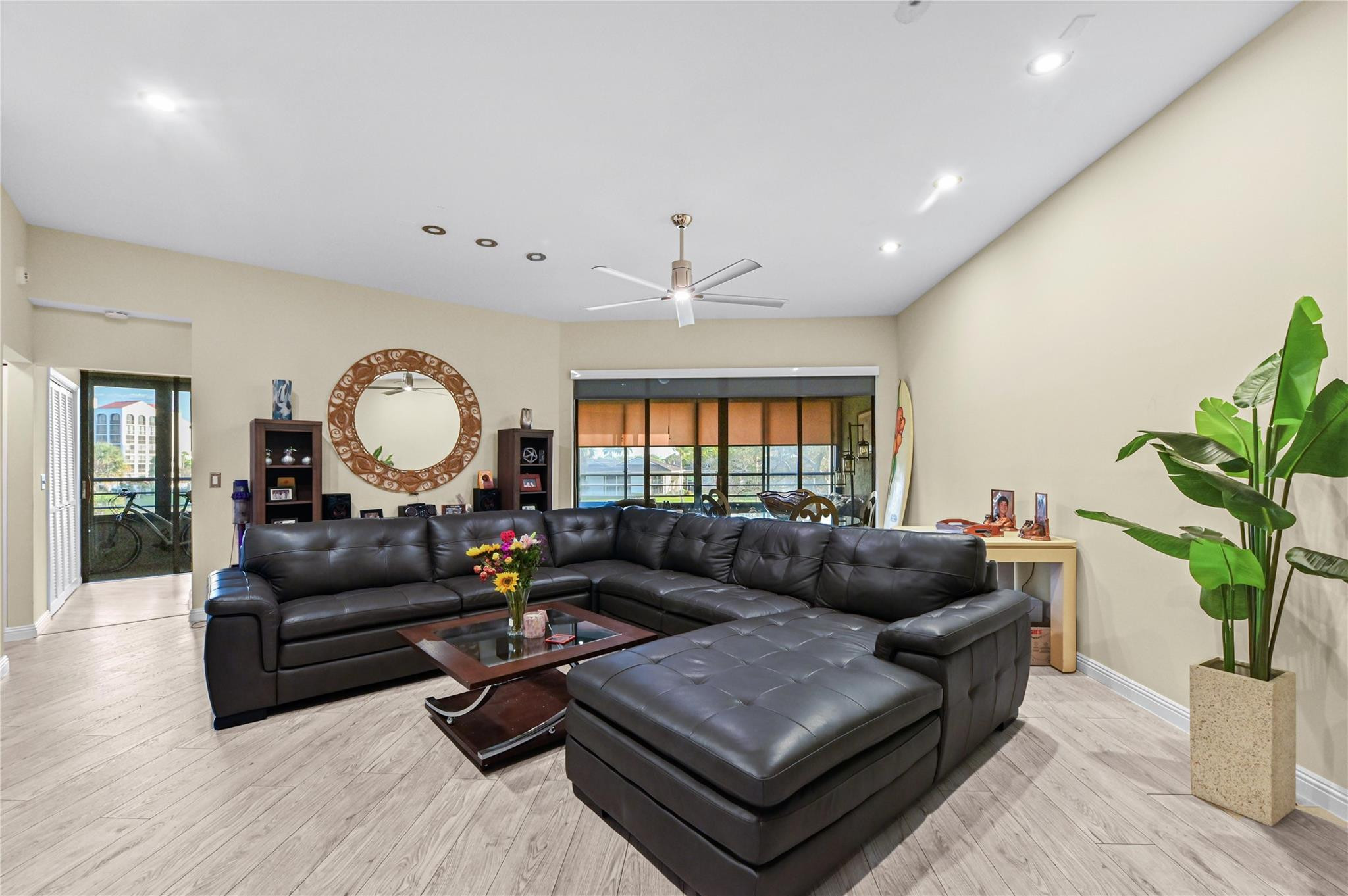 7520 La Paz Boulevard, Unit 306 Boca Raton, FL 33433 - Photo 6 of 36 a living room with furniture potted plant and a large window